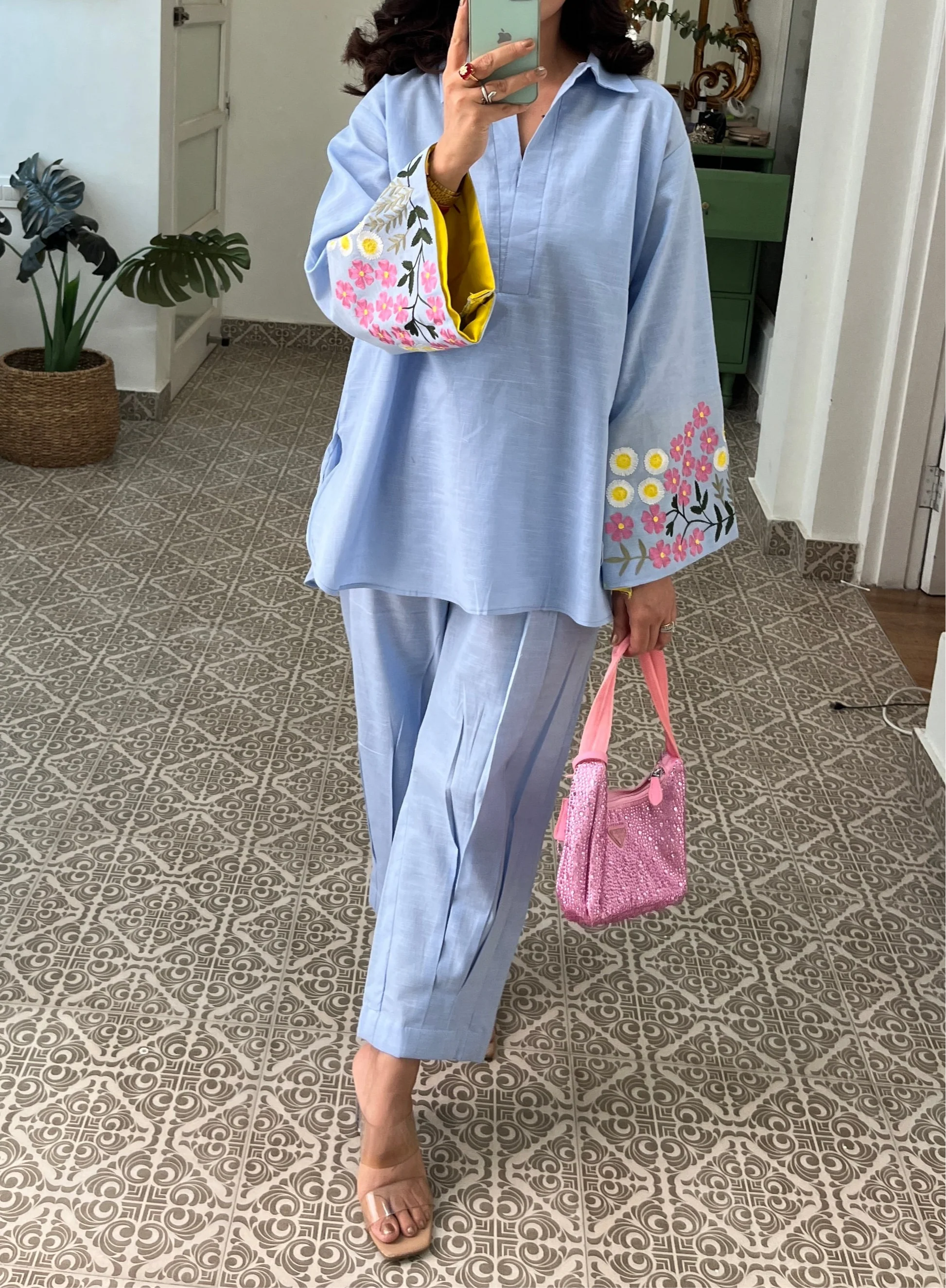Woman wearing sky blue cotton co-ord set with floral embroidered sleeves and straight pants in Pakistani style casual fashion