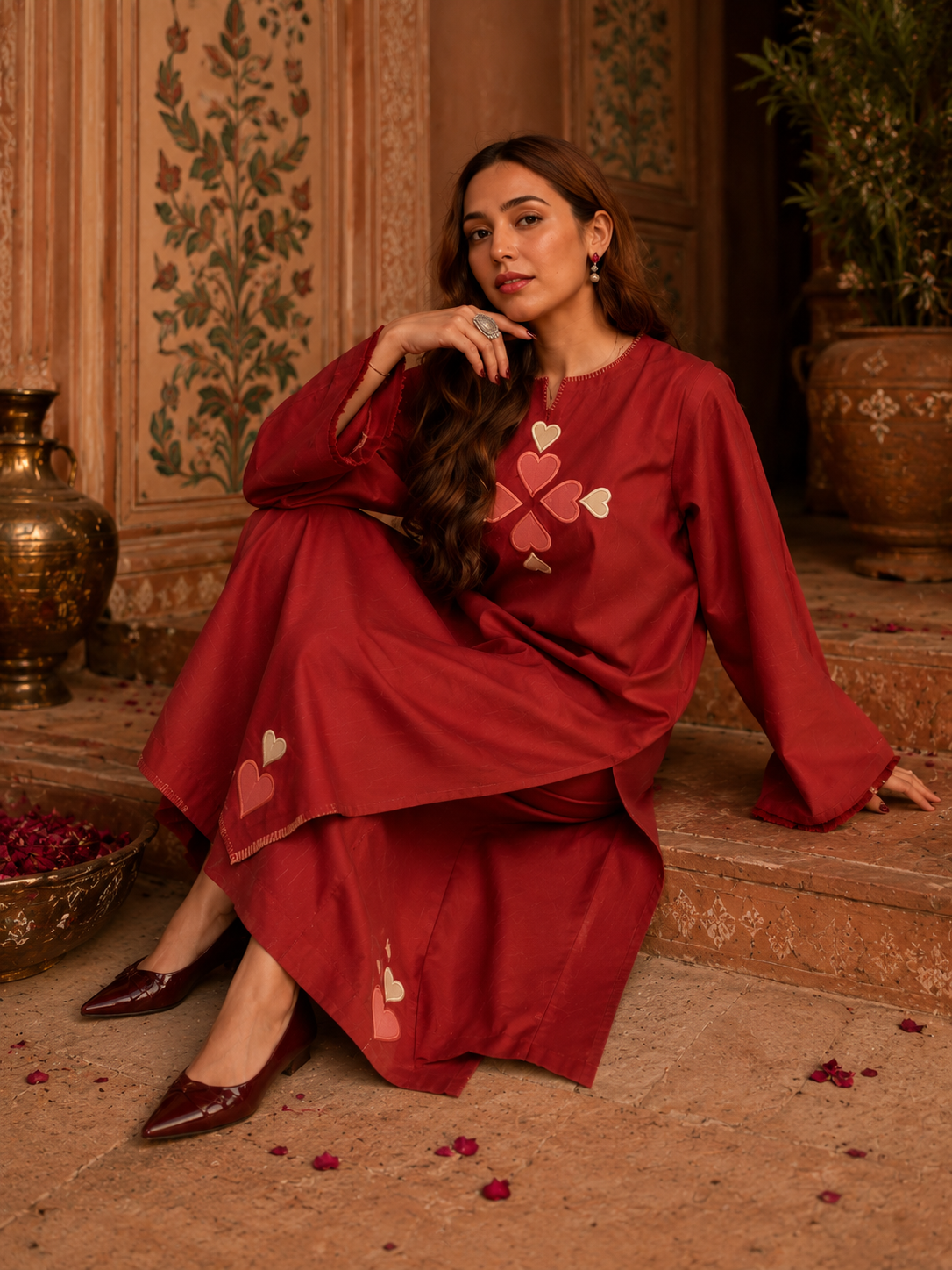 Elegant woman styling red Pakistani inspired cotton co-ord set with designer handbag