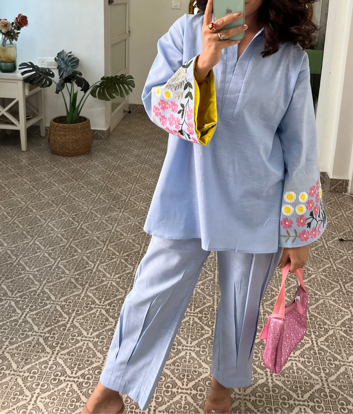 Woman wearing sky blue cotton co-ord set with floral embroidered sleeves and straight pants in Pakistani style casual fashion