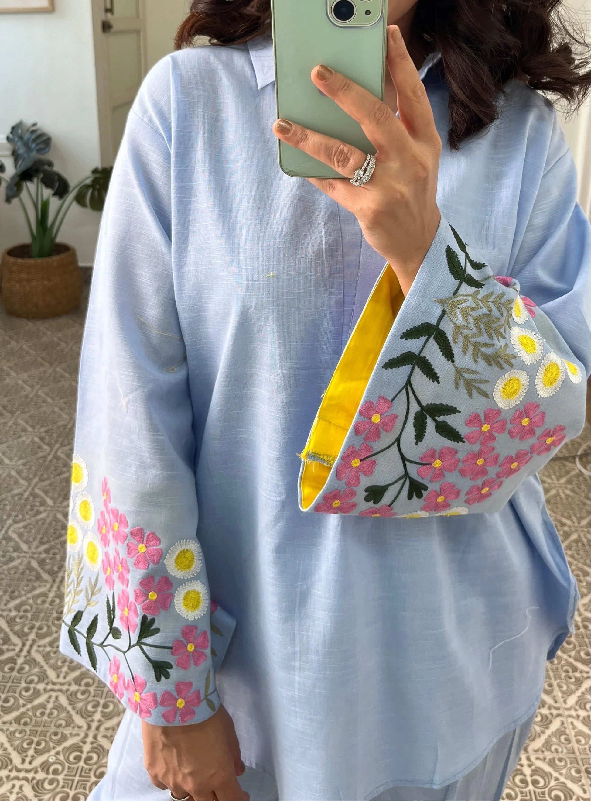 Woman wearing sky blue cotton co-ord set with floral embroidered sleeves and straight pants in Pakistani style casual fashion